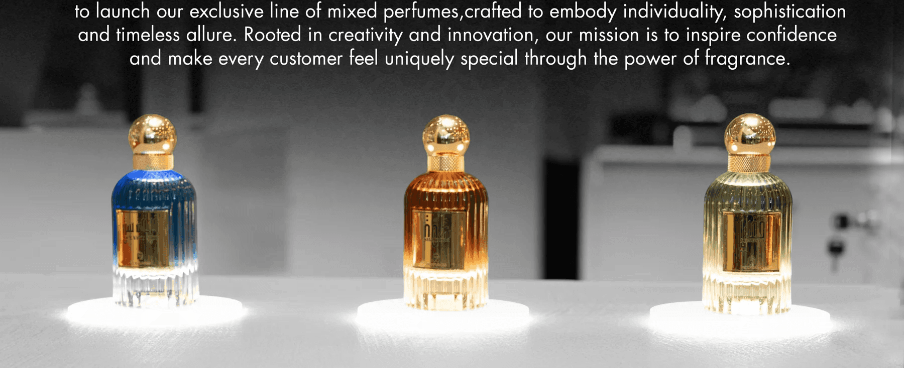 Three 7Perfumes bottles lit on a dark stage